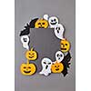 Creative handcraft application with terrible spirits smiling and laughing the pumpkins, black bats on a gray background, copy space. Halloween concept. Flat lay.