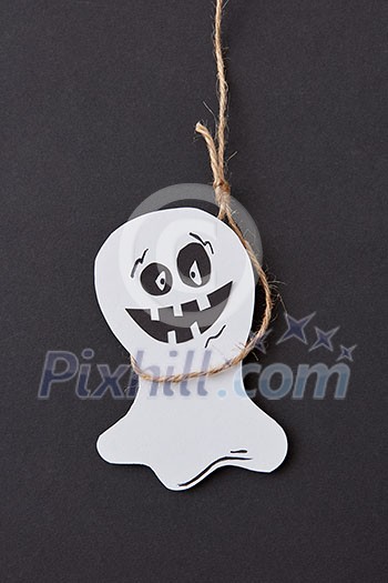 Creative application handcraft from white paper with decorative terrible spirits smiling on a black background, place for text. Halloween concept. Flat lay. Creative application handcraft from white paper with decorative terrible spirits smiling on a black background, place for text. Halloween concept. Flat lay.