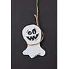 Creative application handcraft from white paper with decorative terrible spirits smiling on a black background, place for text. Halloween concept. Flat lay.