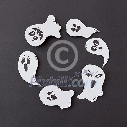 Greeting card, creative application with handmade paper terrible spirits smiling and laughing ghosts on a black background, copy space. Flat lay Greeting card, creative application with handmade paper terrible spirits smiling and laughing ghosts on a black background, copy space. Flat lay