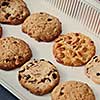 Baking tray with homemade vegetarian cookies with peanuts, chocolate chips, raisins. Healthy vegan food eating.