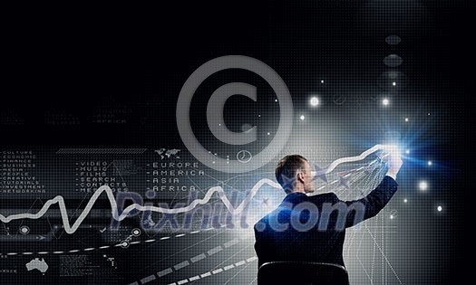 Back view of businessman working with virtual panel Back view of businessman working with virtual panel