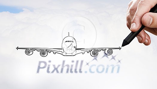 Person drawing airplane model on sky background Person drawing airplane model on sky background