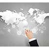 Businessman hand touching icon on world map concept