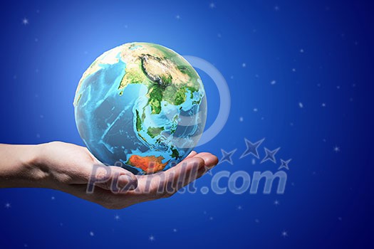 Close up of human hands holding Earth planet. Elements of this image are furnished by NASA Close up of human hands holding Earth planet. Elements of this image are furnished by NASA