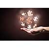 Human hand holding in palm puzzle elements