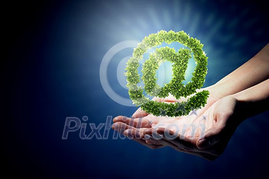 Close up of hands holding green email symbol Close up of hands holding green email symbol