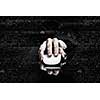 Hand of businessman in suit on dark digital background using wireless computer mouse