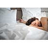 Beautiful young woman sleeping on bed at bedroom