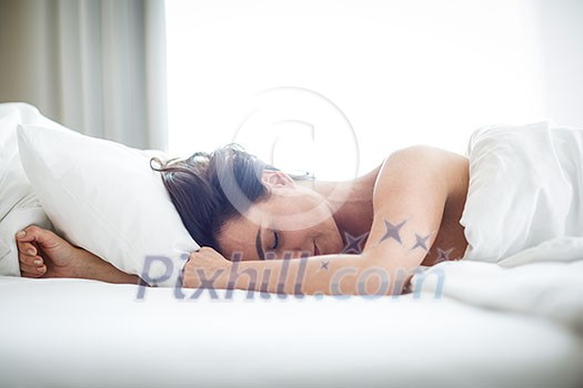Beautiful young woman sleeping on bed at bedroom