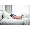 Beautiful young woman sleeping on bed at bedroom
