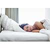 Beautiful young woman sleeping on bed at bedroom