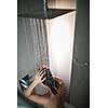 Woman taking a long hot shower washing her hair in a modern design bathroom
