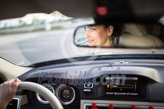 Pretty, young woman driving a car -Invitation to travel. Car rental or vacation. Pretty, young woman driving a car -Invitation to travel. Car rental or vacation.