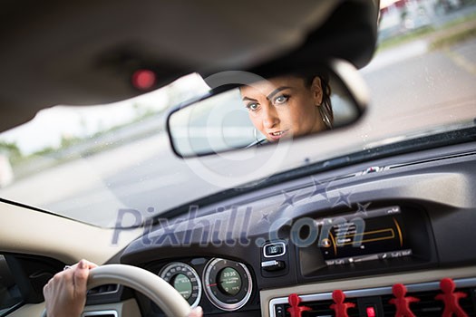 Pretty, young woman driving a car -Invitation to travel. Car rental or vacation. Pretty, young woman driving a car -Invitation to travel. Car rental or vacation.