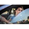 Pretty, young woman  driving a car -Invitation to travel. Car rental or vacation.