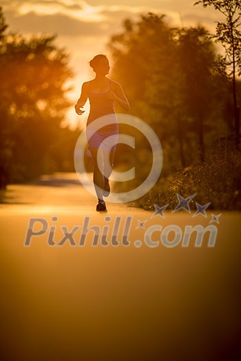 Young woman running outdoors on a lovely sunny summer evening (shallow DOF; color toned image) Young woman running outdoors on a lovely sunny summer evening (shallow DOF; color toned image)