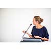 Pretty, young business woman giving a presentation in a conference/meeting setting (shallow DOF; color toned image)