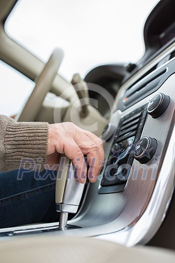 Senior man driving his modern car, going in reverse, watching out not to hit anything or anyone (color toned image; shallow DOF) Senior man driving his modern car, going in reverse, watching out not to hit anything or anyone (color toned image; shallow DOF)