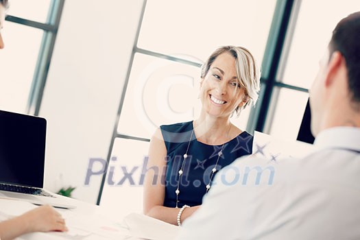 Female manager assessing work of her employees Female manager assessing work of her employees