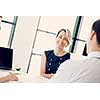 Female manager assessing work of her employees