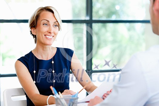 Business woman discussing new project with her partners Business woman discussing new project with her partners