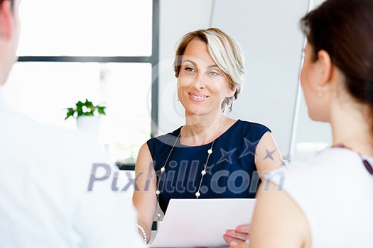 Business woman discussing new project with her partners Business woman discussing new project with her partners