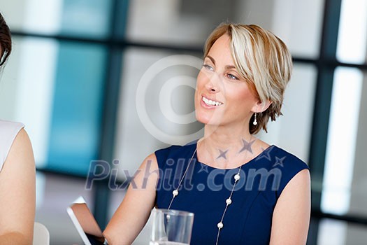 Businesswoman in blue dress sitting at meeting Businesswoman in blue dress sitting at meeting