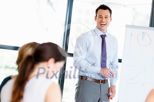 Businessman doing a presentaion in front of his collegues Businessman doing a presentaion in front of his collegues