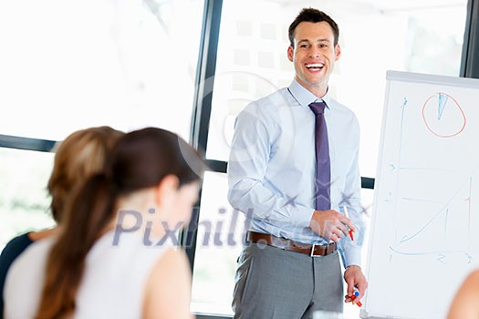 Businessman doing a presentaion in front of his collegues Businessman doing a presentaion in front of his collegues