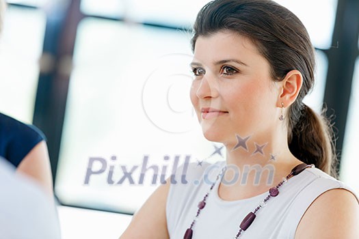 Businesswoman having a discussion with her collegues Businesswoman having a discussion with her collegues