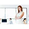 Young businesswoman standing in office with her collegue on the background