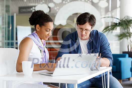 Shot of a young office worker getting some assistance from her manager Shot of a young office worker getting some assistance from her manager