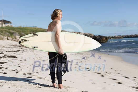 A surfer with his surfboard at the beach A surfer with his surfboard at the beach