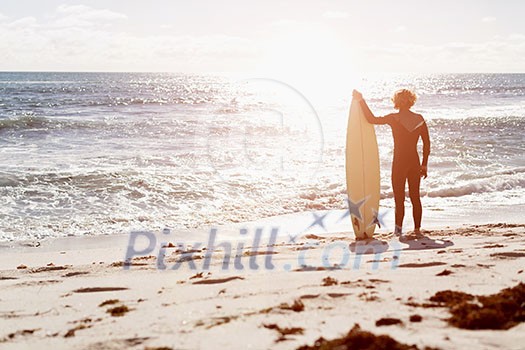 A surfer with his surfboard at the beach A surfer with his surfboard at the beach
