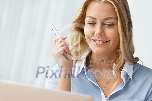 Businesswoman smiling and sitting in offfice Businesswoman smiling and sitting in offfice