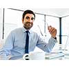 Young businessman in office sitting and smiling
