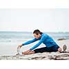 Sporty young woman exercising on the sea coast
