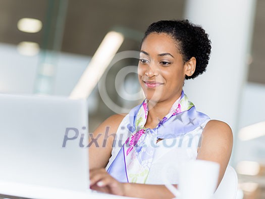 Young business woman working with laptop in office Young business woman working with laptop in office