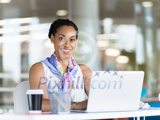Young business woman working with laptop in office Young business woman working with laptop in office