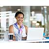 Young business woman working with laptop in office