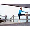 Sporty young woman on the sea coast