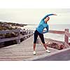 Sporty young woman on the sea coast