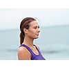 Sporty young woman standing on the sea coast