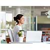 Happy and confident young woman in an office