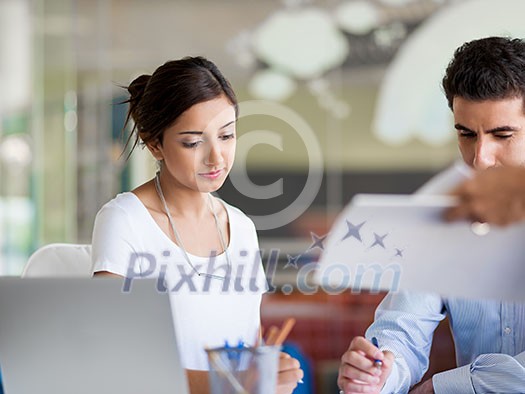 Two collegues working together in an office Two collegues working together in an office