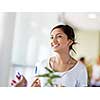 Happy and confident young woman in an office