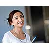 Happy and confident young woman in an office