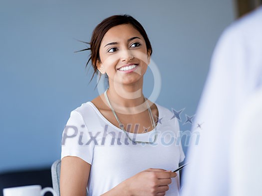 Young business woman talking to her collegue and smiling Young business woman talking to her collegue and smiling