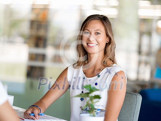 Happy and confident young woman in an office Happy and confident young woman in an office